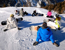 Snowboarders relaxing on the slope